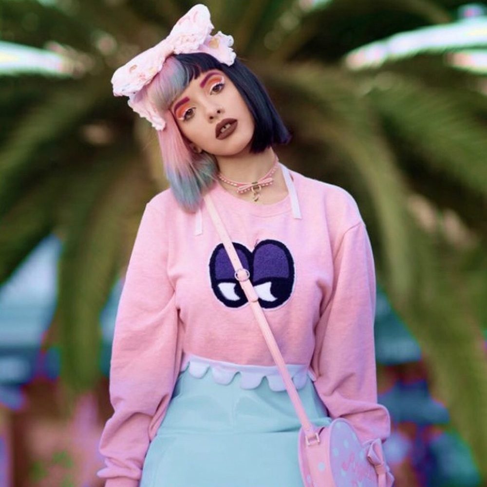 pink long sleeve crop-top with fuzzy eyes.